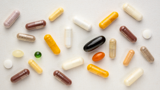 NAD and NMN supplements sit on a white tabletop